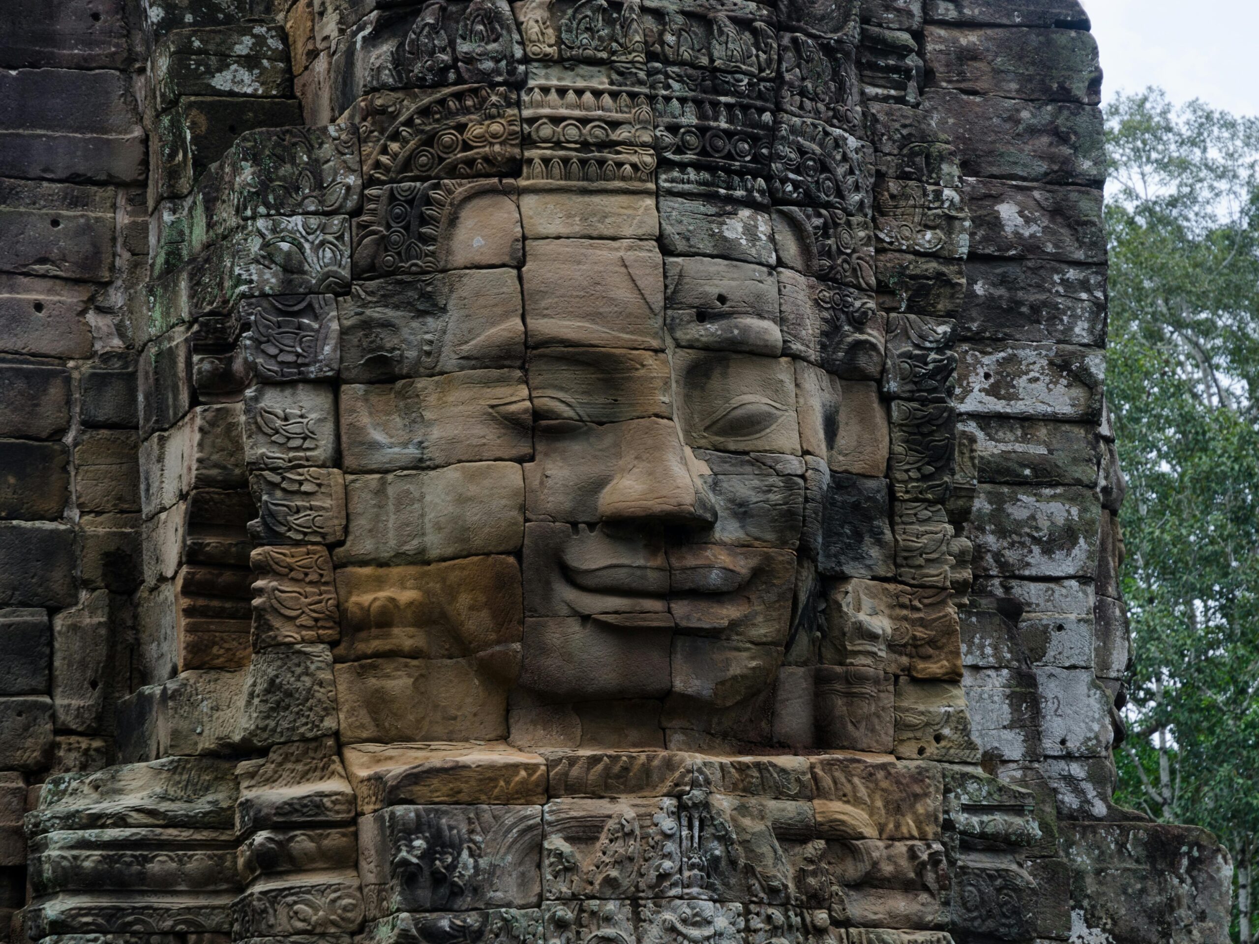 Close-up of a serene stone face at Bayon Temple in Siem Reap, Cambodia.